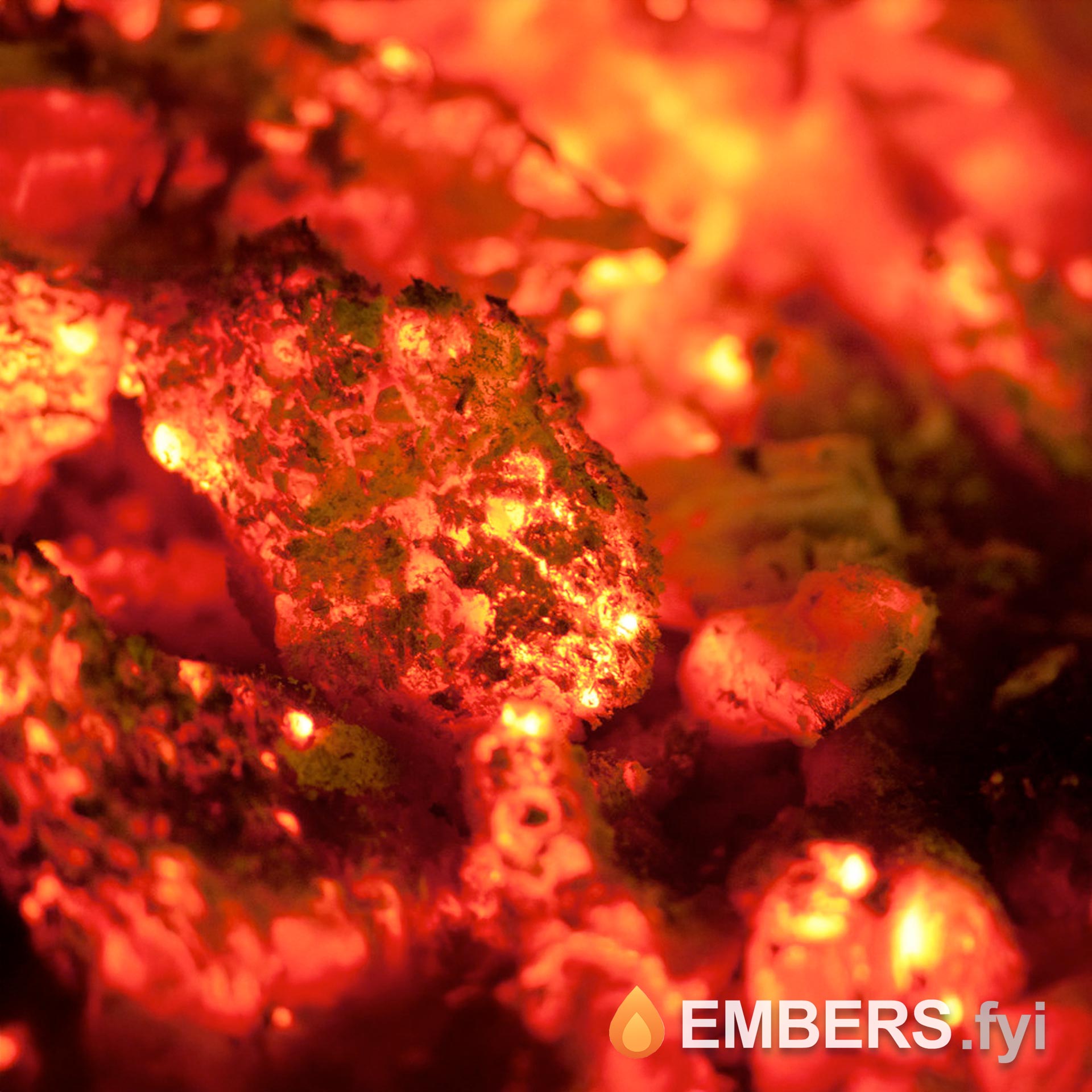 Close‑up view of glowing red embers in a fire