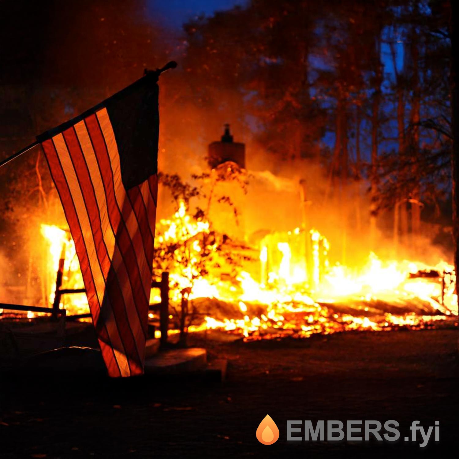 A house burning fiercely at night while a U.S. flag waves in the foreground